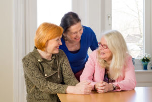 Happy Middle Age Women at Dining Table